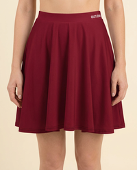 OUTLENA Elevate Skater Skirt Burgundy on model, logo detail