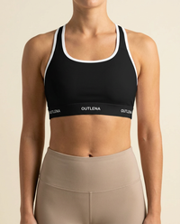 Model wearing OUTLENA Elevate Contrast Sports Bra Onyx Black